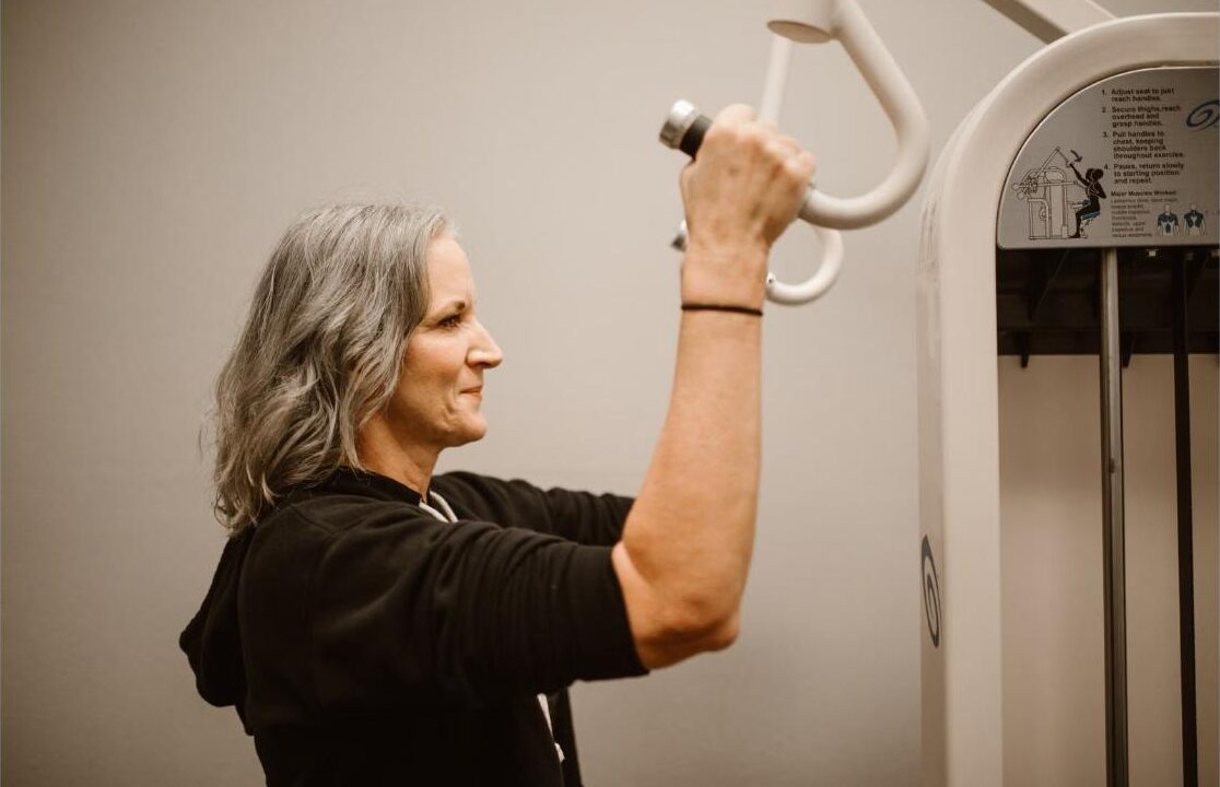 Woman over 50 doing strength training to prevent sarcopenia and muscle loss