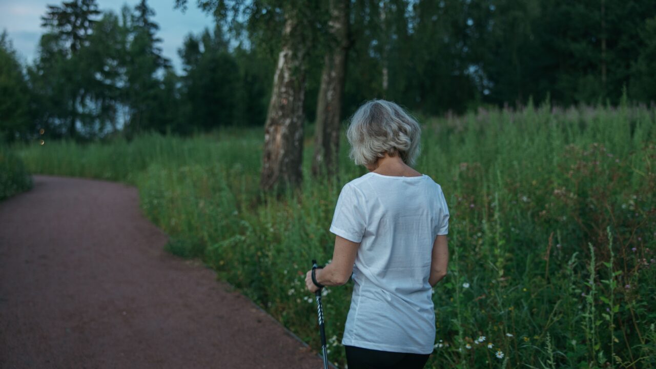 Mature woman walking outdoors, illustrating gait speed as a functional health marker