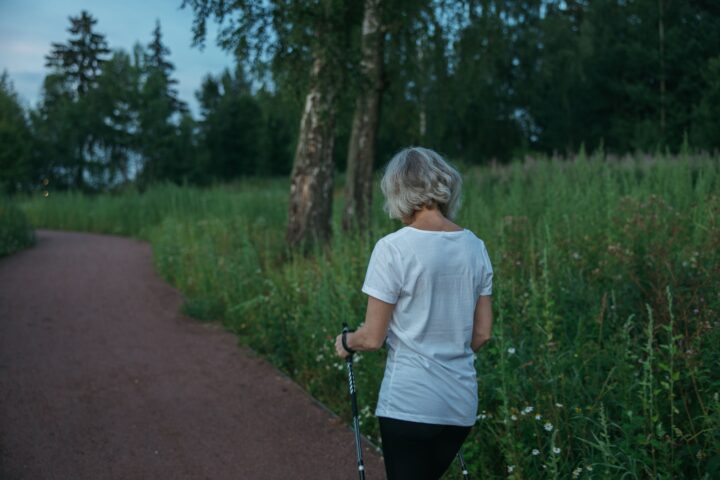 Mature woman walking outdoors, illustrating gait speed as a functional health marker