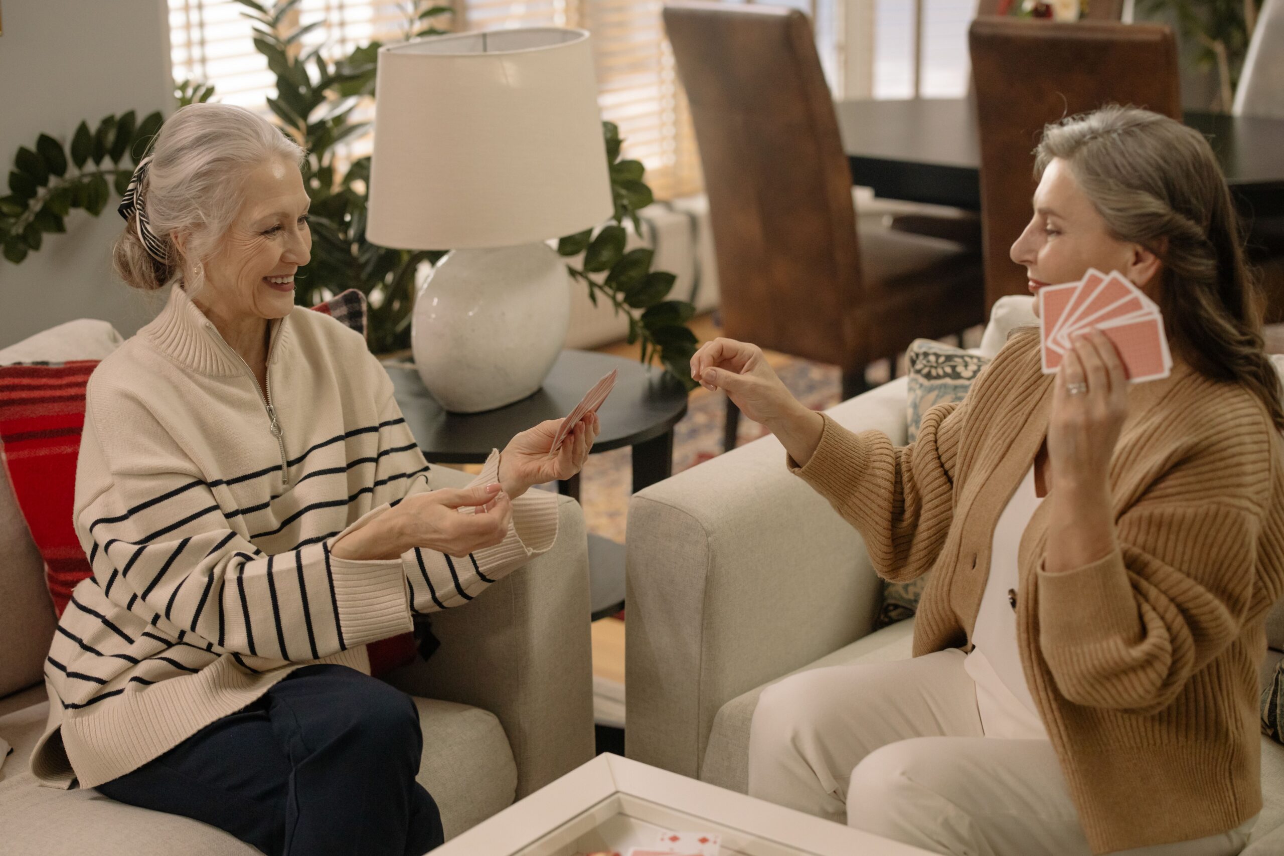 Senior women playing cards together, an example of social and mentally stimulating activity