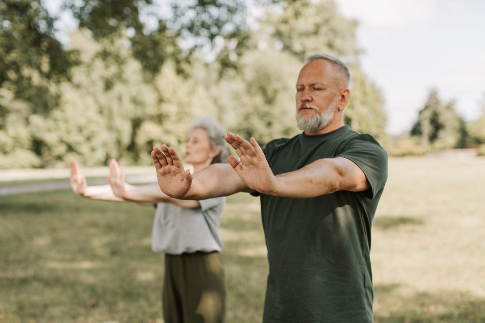 Older adults practicing tai chi outdoors, an exercise CDC recommends for fall prevention